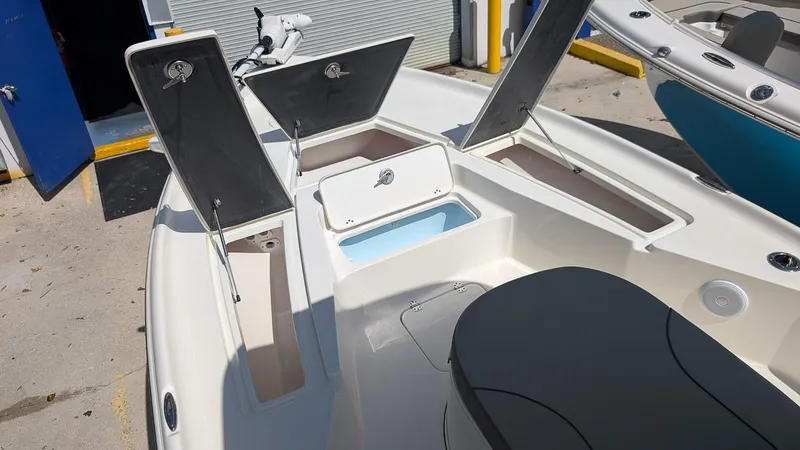 Slide: The Image of 2025 Key West 250 Bay Reef boat interior with open storage compartments. - 10