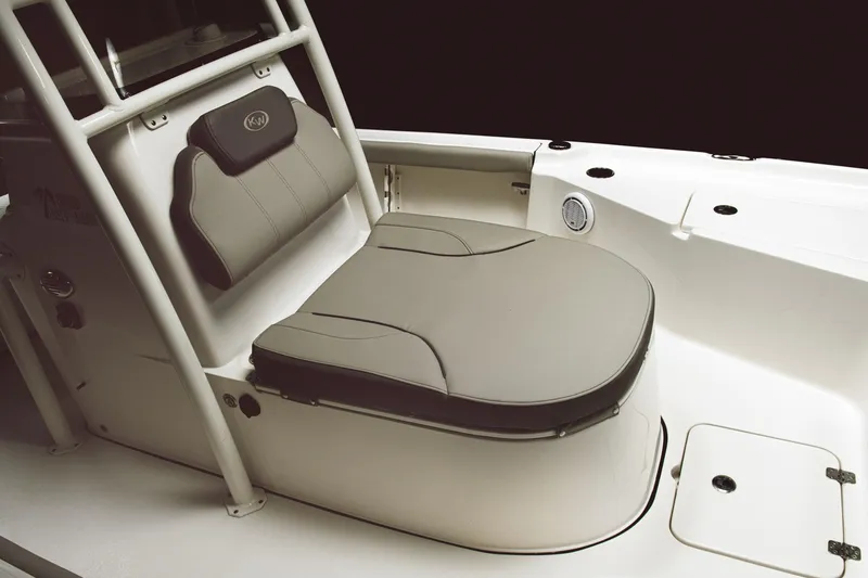 Slide: The Image of 2024 Key West 250 Bay Reef boat seating area with cushioned seat and backrest. - 16