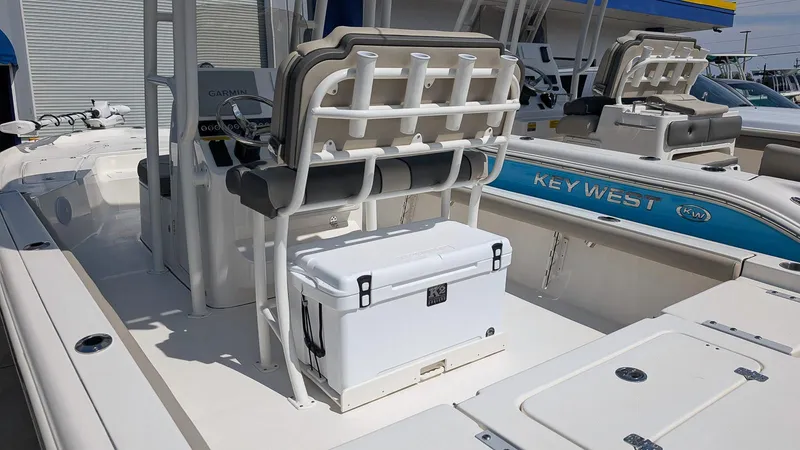 Slide: The Image of 2025 Key West 250 Bay Reef boat interior with seating and cooler. - 2