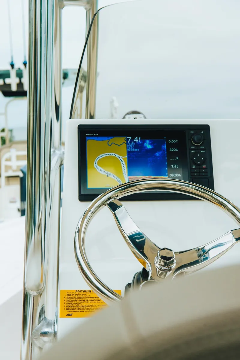Slide: The Image of 2024 Key West 250 Bay Reef boat dashboard with navigation display. - 23