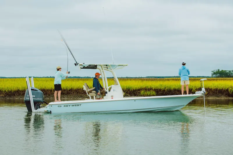 Slide: The Image of 2025 Key West 250 Bay Reef boat with people fishing in calm waters. - 28