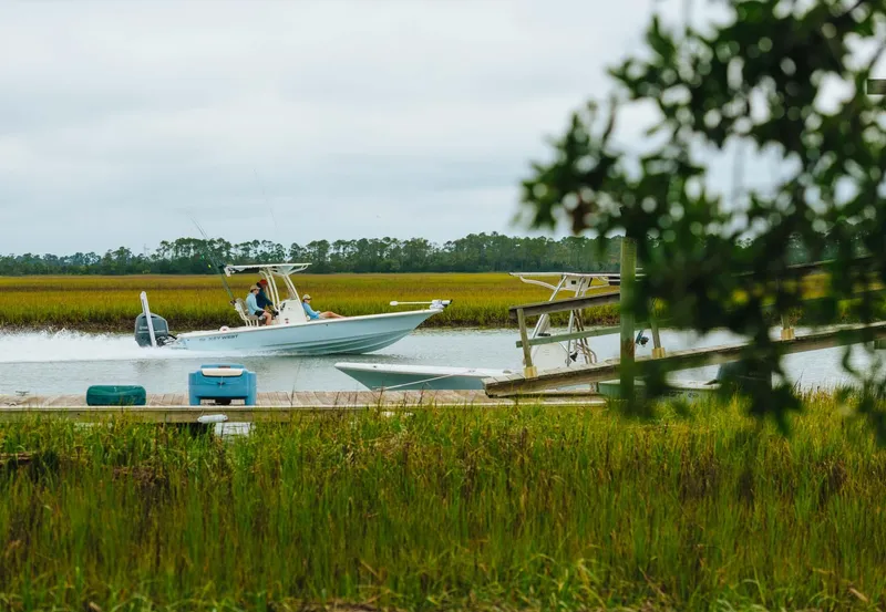 Slide: The Image of 2025 Key West 250 Bay Reef boat cruising through marshland waters. - 33