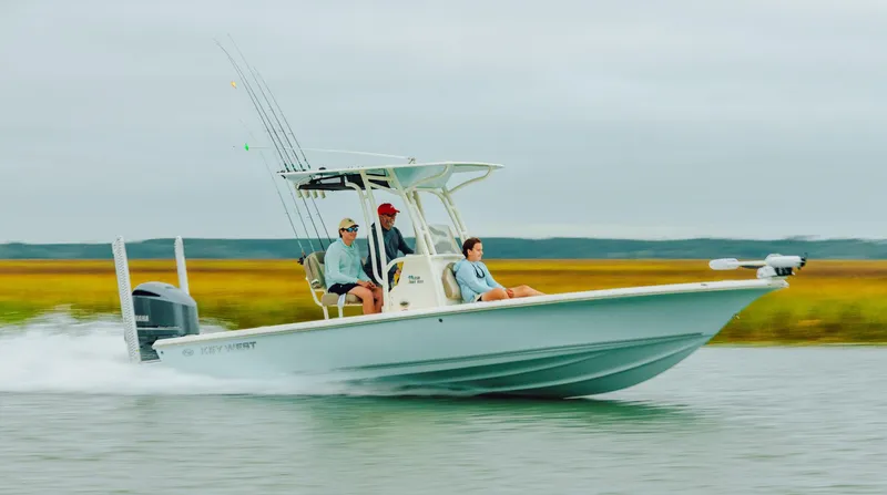Slide: The Image of 2026 Key West 250 Bay Reef boat cruising on water with passengers. - 42