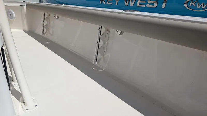 Slide: The Image of 2025 Key West 250 Bay Reef boat interior detail with rod holders. - 5