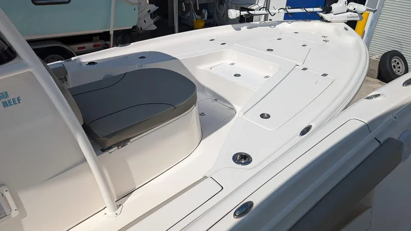 Slide: The Image of 2025 Key West 250 Bay Reef boat interior with seating and storage compartments. - 9