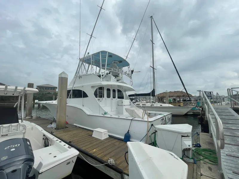The Image of Custom Carolina 47 Alex Willis 2004 yacht docked at marina on a cloudy day. - 1