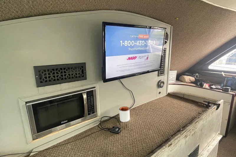 Slide: The Image of Interior of 2004 Custom Carolina 47 Alex Willis boat with TV, microwave, and cup. - 10