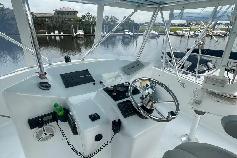 Slide: The Image of Helm of 2004 Custom Carolina 47 Alex Willis boat docked at marina. - 13