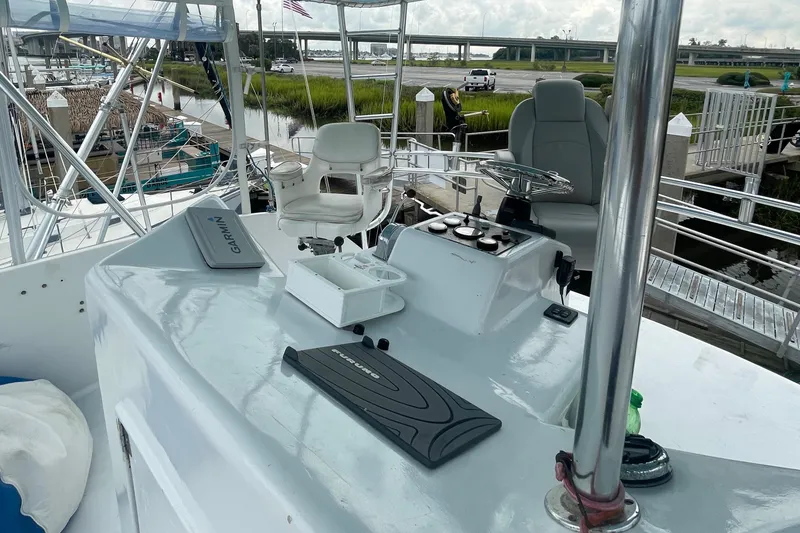 Slide: The Image of Helm station of 2004 Custom Carolina 47 Alex Willis boat docked at marina. - 14