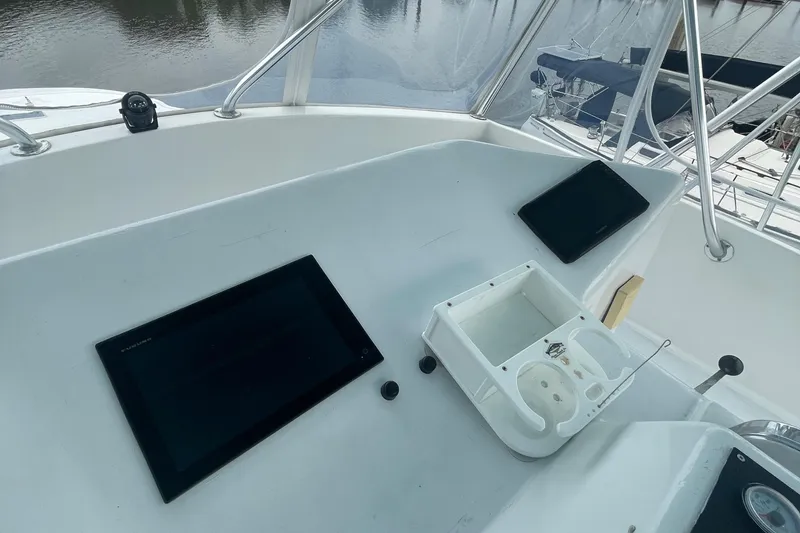 Slide: The Image of Helm station of 2004 Custom Carolina 47 Alex Willis boat with navigation screens. - 15