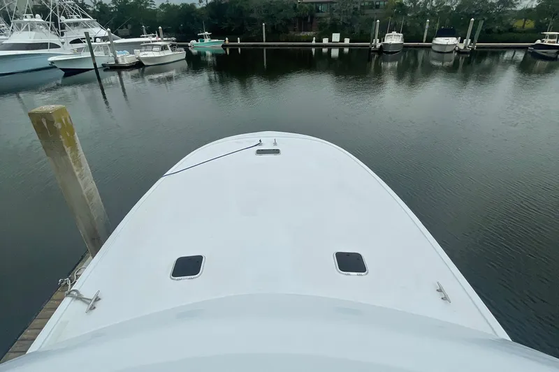 Slide: The Image of Bow view of 2004 Custom Carolina 47 Alex Willis yacht docked in marina. - 20