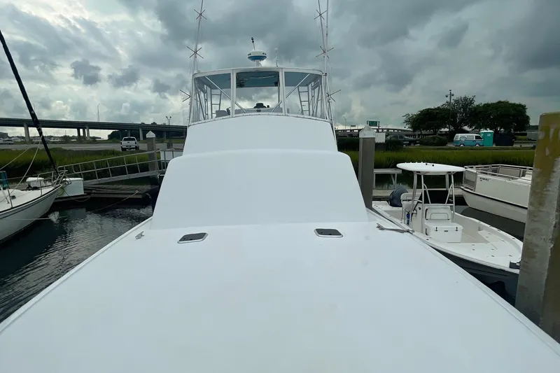Slide: The Image of 2004 Custom Carolina 47 Alex Willis boat docked at marina under cloudy sky. - 25