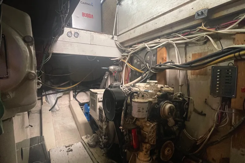 Slide: The Image of Engine room of a 2004 Custom Carolina 47 Alex Willis boat with visible machinery and wiring. - 31