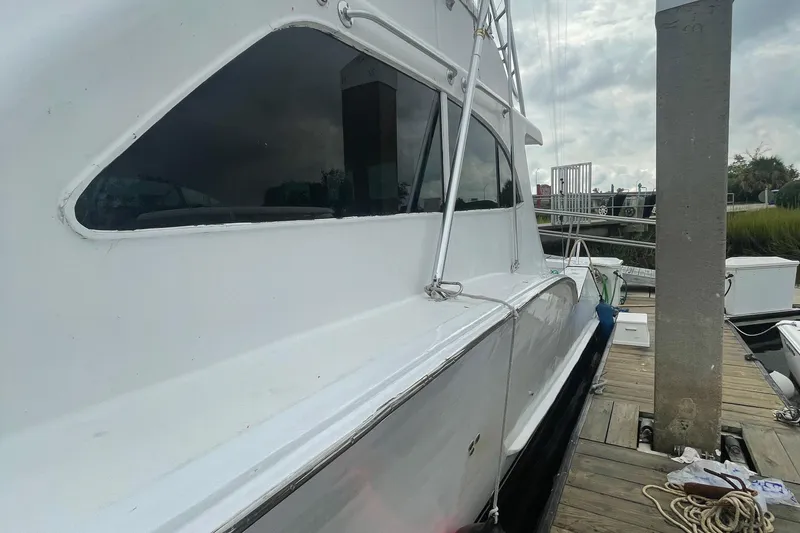 Slide: The Image of 2004 Custom Carolina 47 Alex Willis yacht docked at marina. - 5