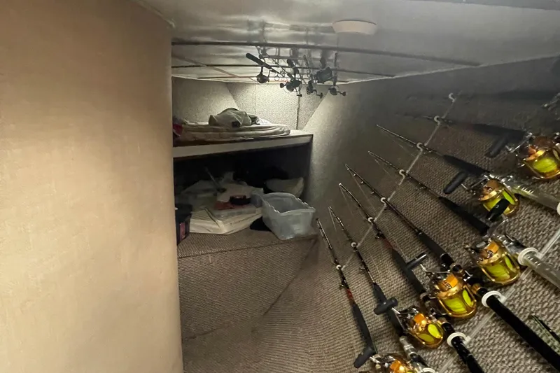 Slide: The Image of Interior of 2004 Custom Carolina 47 Alex Willis boat with fishing rods and storage area. - 9