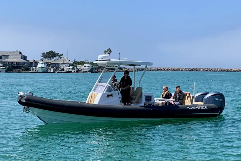 The Image of 2024 Highfield Sport 900 boat cruising on clear blue water. - 2