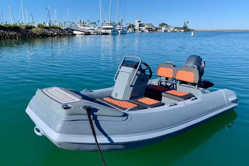 The Image of 2024 Highfield Sport 330 boat docked in a marina with sailboats in the background. - 3