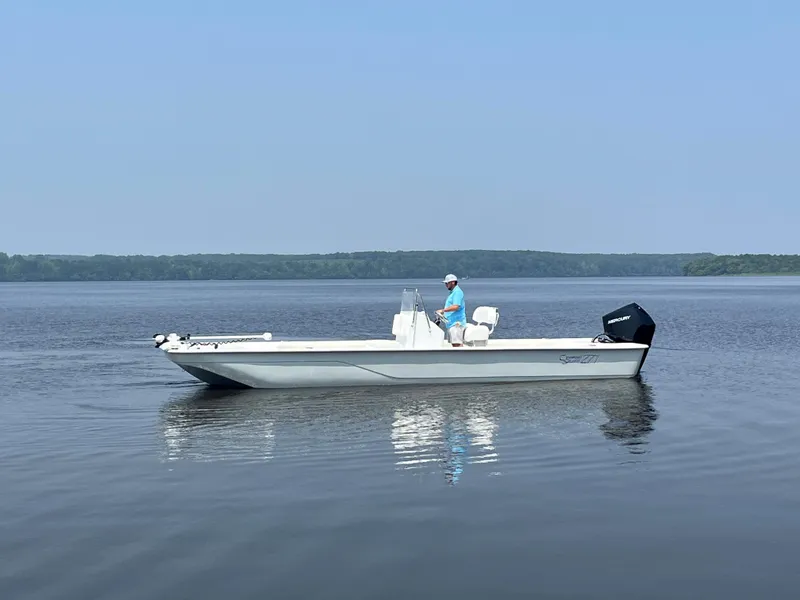 Slide: The Image of 2024 Coastal Skiff 271 boat on calm water. - 17