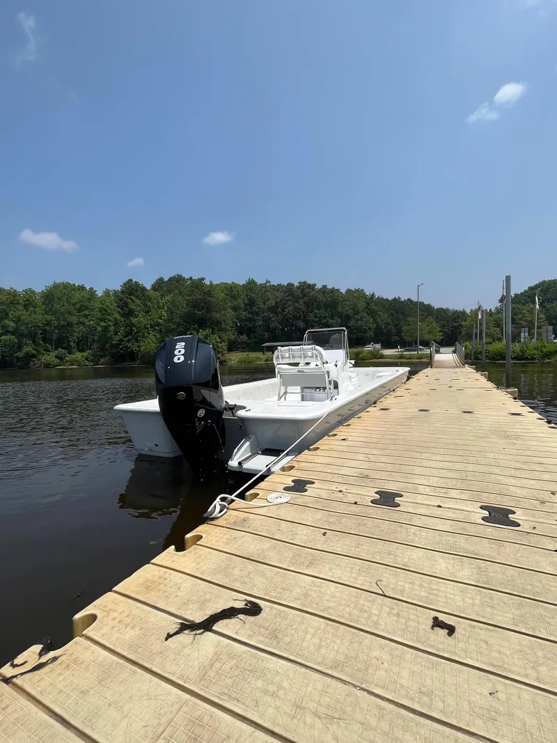 Slide: The Image of 2024 Coastal Skiff 271 docked on a sunny day. - 7
