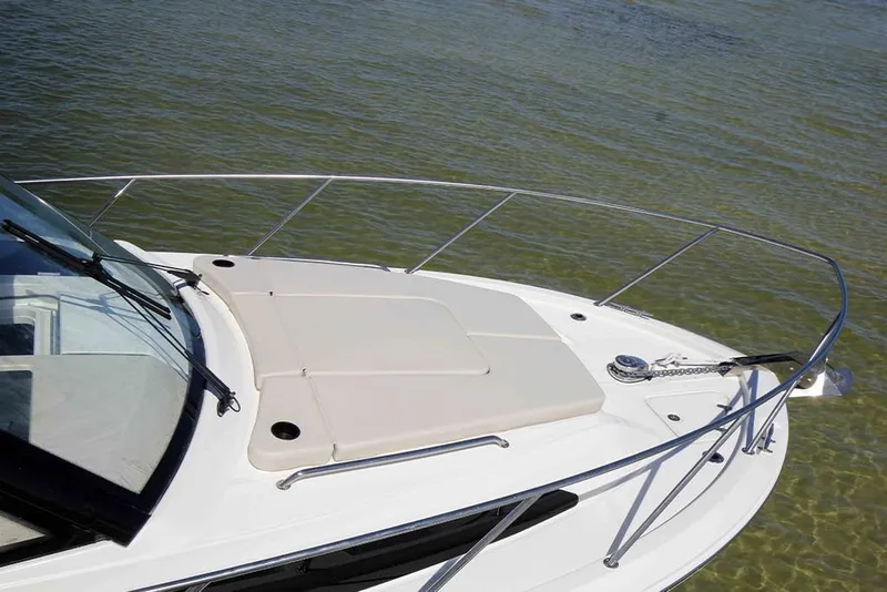 Slide: The Image of 2024 Boston Whaler 325 Conquest bow deck with cushioned seating. - 3