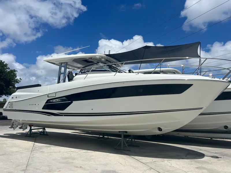 Slide: The Image of 2024 Jeanneau Leader 12.5 boat on display under a blue sky. - 0