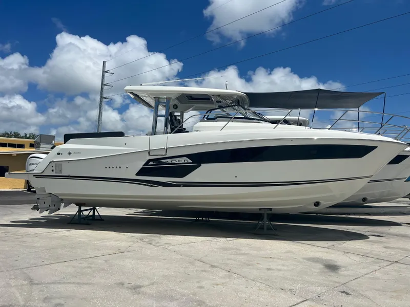 Slide: The Image of 2024 Jeanneau Leader 12.5 boat on display under a clear blue sky. - 1