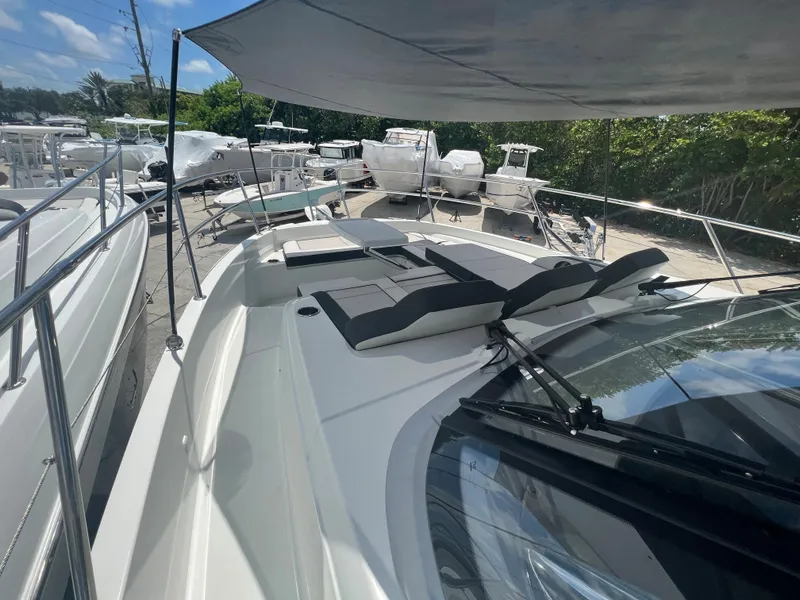 Slide: The Image of 2024 Jeanneau Leader 12.5 boat with spacious deck and sun loungers. - 11