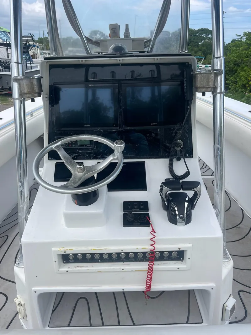 Slide: The Image of 2000 Contender 36 Open boat helm with steering wheel, controls, and navigation screens. - 1