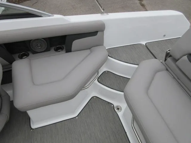 Slide: The Image of 2024 Four Winns HD3 boat interior with gray cushioned seating and integrated speakers. - 14