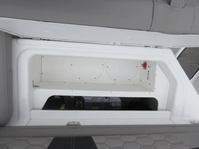 Slide: The Image of 2024 Four Winns HD3 storage compartment with battery switch and equipment. - 15