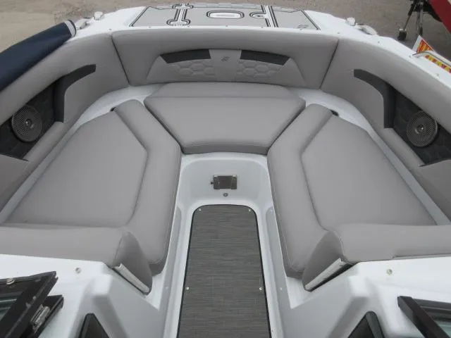 Slide: The Image of 2024 Four Winns HD3 boat interior with gray cushioned seating and integrated speakers. - 20