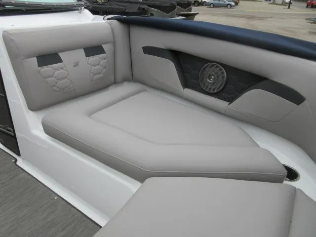 Slide: The Image of 2024 Four Winns HD3 boat interior with gray cushioned seating and built-in speaker. - 21