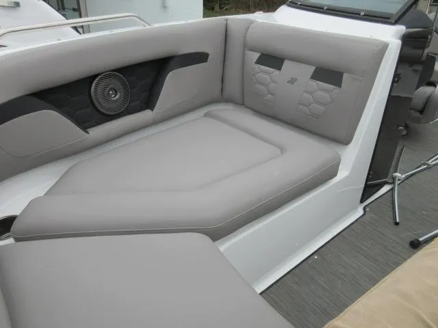 Slide: The Image of 2024 Four Winns HD3 boat interior with gray cushioned seating and built-in speaker. - 22