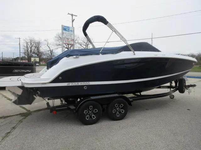 Slide: The Image of 2024 Four Winns HD3 boat on a trailer, covered and ready for transport. - 3