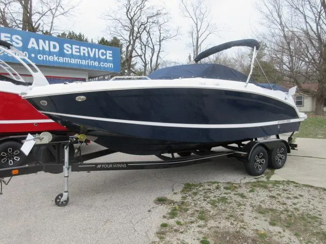 Slide: The Image of 2024 Four Winns HD3 boat on a trailer at a dealership. - 4