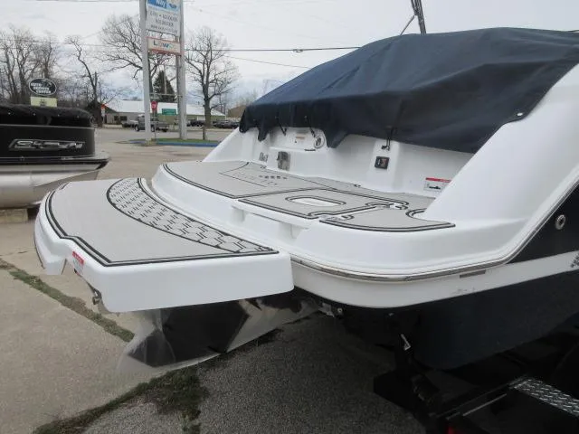 Slide: The Image of 2024 Four Winns HD3 boat rear view with swim platform and cover. - 6