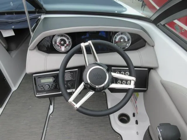 Slide: The Image of 2024 Four Winns HD3 boat dashboard with steering wheel and control panel. - 7
