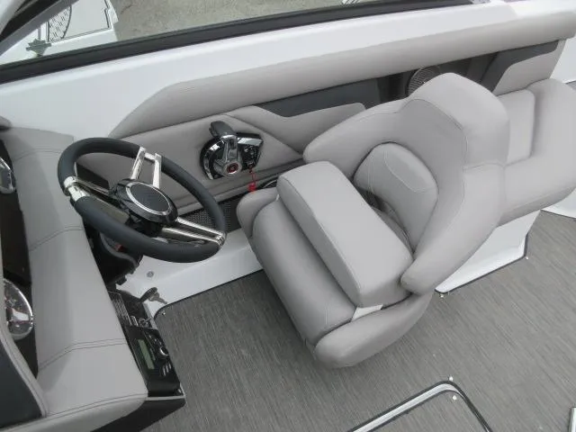Slide: The Image of 2024 Four Winns HD3 boat cockpit with gray captain's seat and steering wheel. - 9