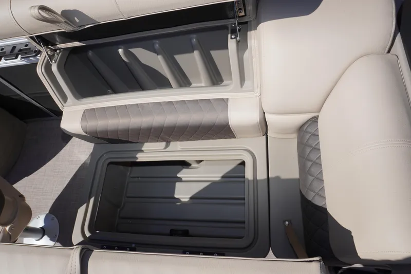 Slide: The Image of 2024 Sun Tracker Fishin' Barge 20 DLX storage compartment with cushioned seating. - 14