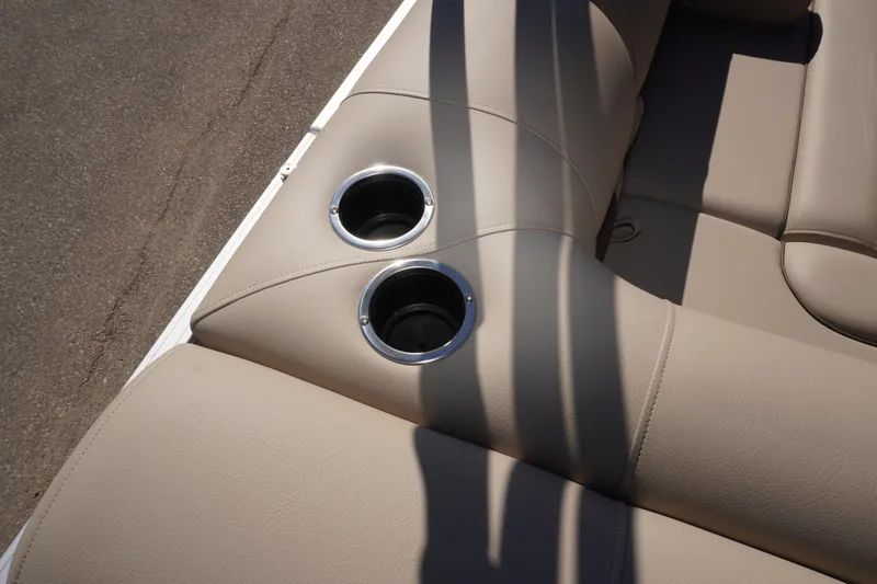 Slide: The Image of 2024 Sun Tracker Fishin' Barge 20 DLX beige seating with dual cup holders. - 15