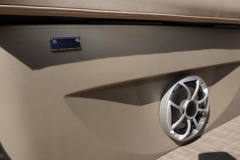 Slide: The Image of 2024 Sun Tracker Fishin' Barge 20 DLX speaker detail, beige interior. - 16