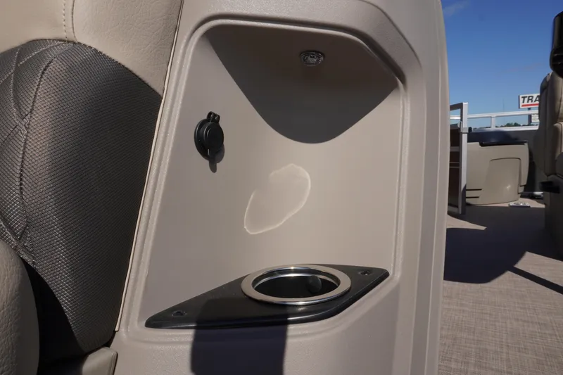 Slide: The Image of 2024 Sun Tracker Fishin' Barge 20 DLX interior with cup holder and power outlet. - 17
