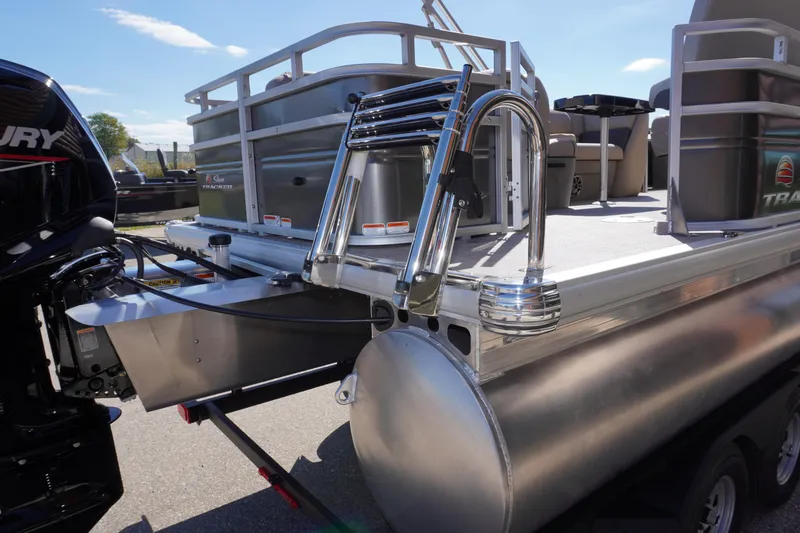 Slide: The Image of 2024 Sun Tracker Fishin' Barge 20 DLX pontoon boat with ladder and outboard motor. - 22