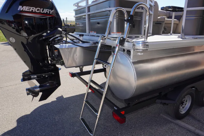 Slide: The Image of 2024 Sun Tracker Fishin' Barge 20 DLX with Mercury engine and ladder on trailer. - 23