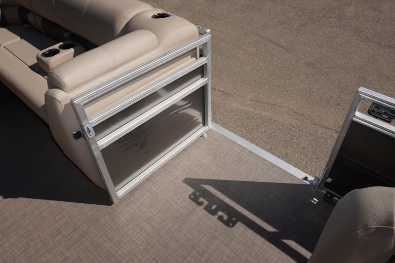 Slide: The Image of 2024 Sun Tracker Fishin' Barge 20 DLX interior with beige seating and cup holders. - 3