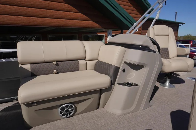Slide: The Image of 2024 Sun Tracker Fishin' Barge 20 DLX interior with beige seating and console. - 4
