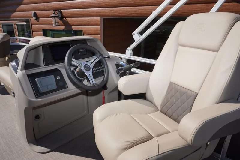 Slide: The Image of 2024 Sun Tracker Fishin' Barge 20 DLX helm with plush captain's chair and modern controls. - 5