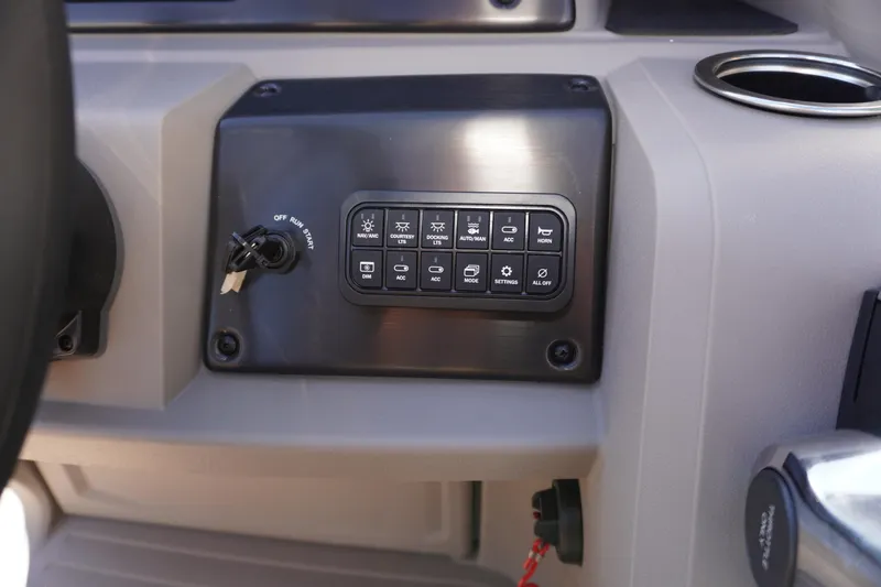 Slide: The Image of Control panel of 2024 Sun Tracker Fishin' Barge 20 DLX with ignition switch and buttons. - 9