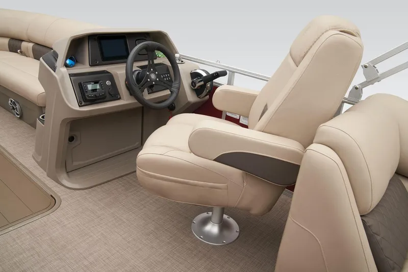 Slide: The Image of 2024 Sun Tracker Party Barge 22 XP3 helm with plush captain's chair and modern controls. - 28