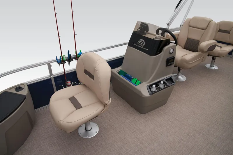 Slide: The Image of 2024 Sun Tracker Bass Buggy 18 DLX interior with beige seats and fishing rod holders. - 27